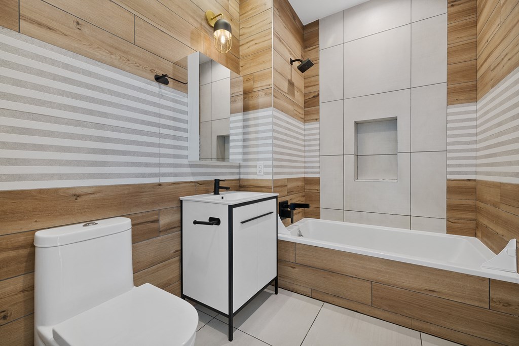 a bathroom with a tub and a toilet and a sink